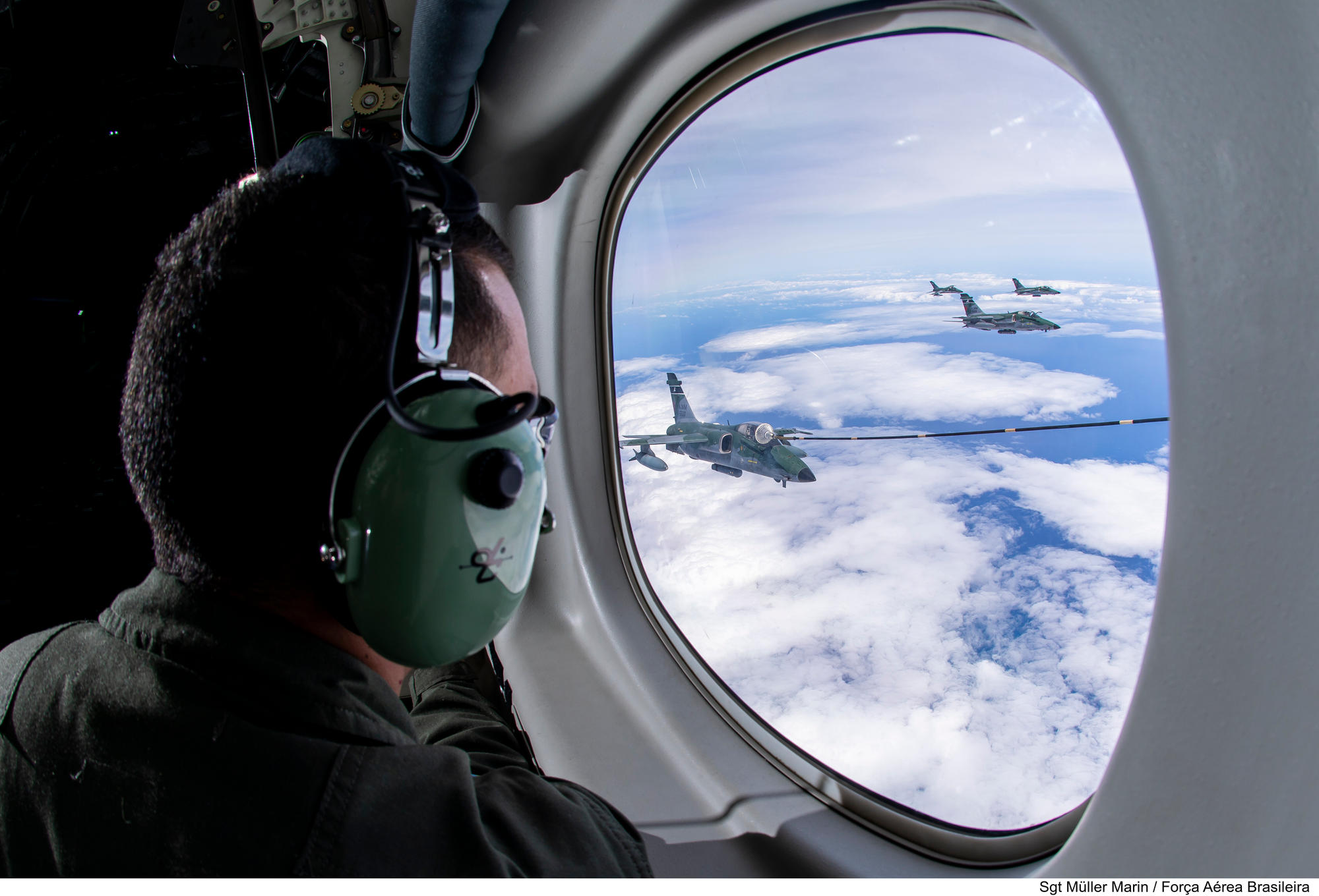 A group of FAB A-1AM on echelon port formation, refuelling from a FAB KC-390 Millenium.